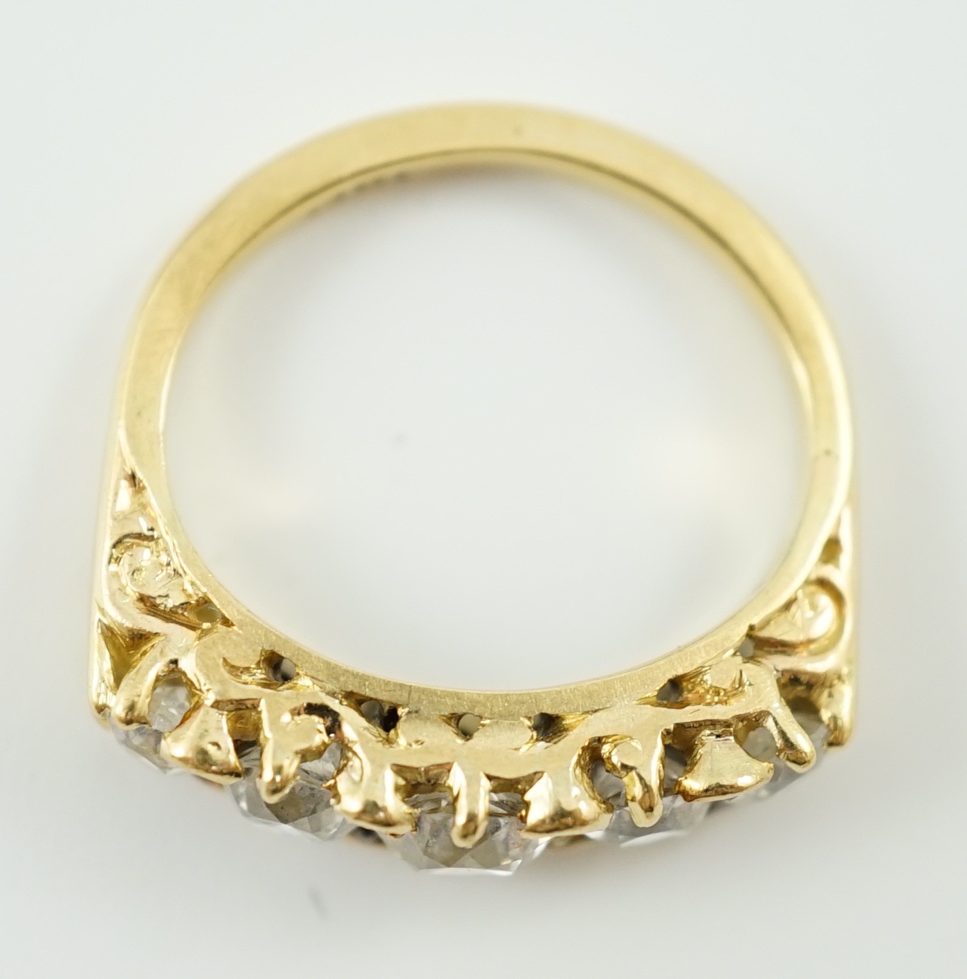 An 18ct gold and graduated five stone diamond set half hoop ring